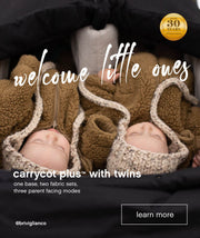 Two babies resting in their twin carrycot plus™ while travelling in a Mountain Buggy double pram