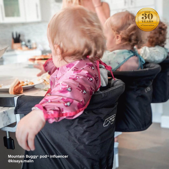 three little kiddies being fed in their pod™ highchairs securely attached to the kitchen bench top - Mountain Buggy pod™ influencer @kisaya.malin