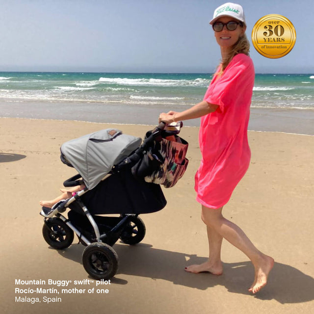 young family at the beach using compact swift™ pram - Ricío-Martín, mother of one Malaga, Spain - Mountain Buggy