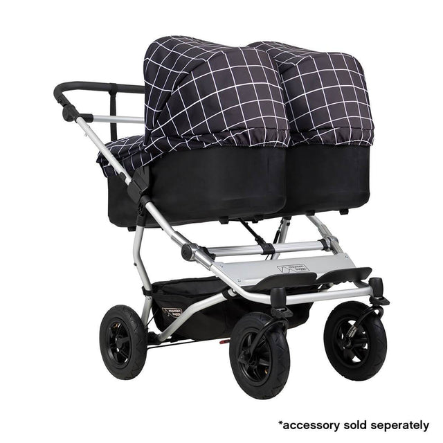 Mountain Buggy duet double buggy fitted with two carrycot plus in parent facing seat position in colour grid_grid