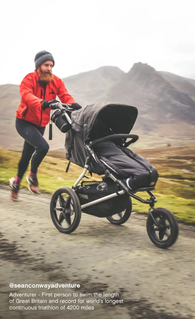 Mountain Buggy terrain all terrain 3-wheel pushchair with sleeping bag – dad running on a mountain trail