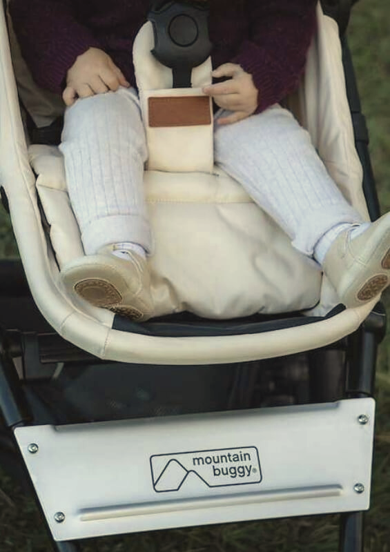 cosmopolitan Artisan collection pram showing front facing toddler with matching chai coloured booties - pilot @sarakrossphotography for mountain buggy