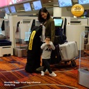 mother with toddler at the airport with luggage - Mountain Buggy travel bag influencer @kellynting
