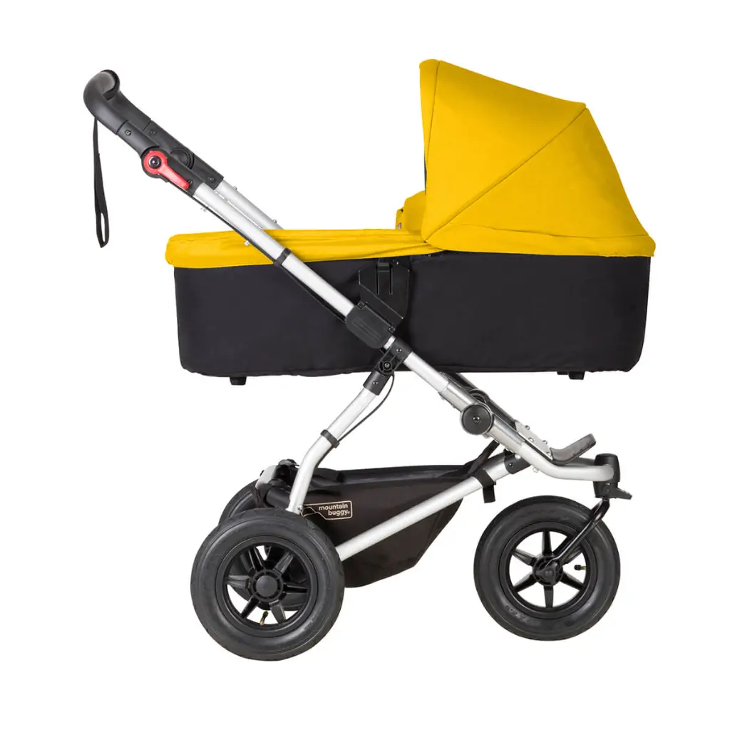 Mountain-Buggy-gold-carrycot-plus-on-swift-buggy-in-lie-flat-mode-side-view.webp