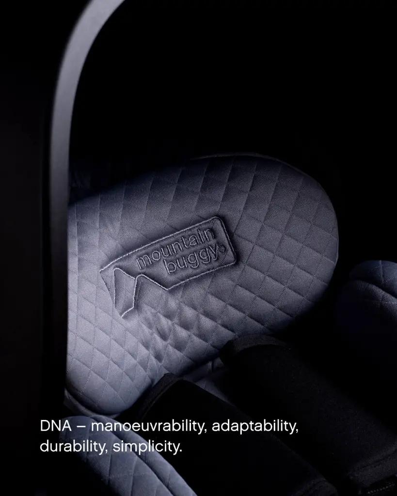 mountain-buggy-nest-car-seat-quilted-newborn-insert-logo-closeup.webp