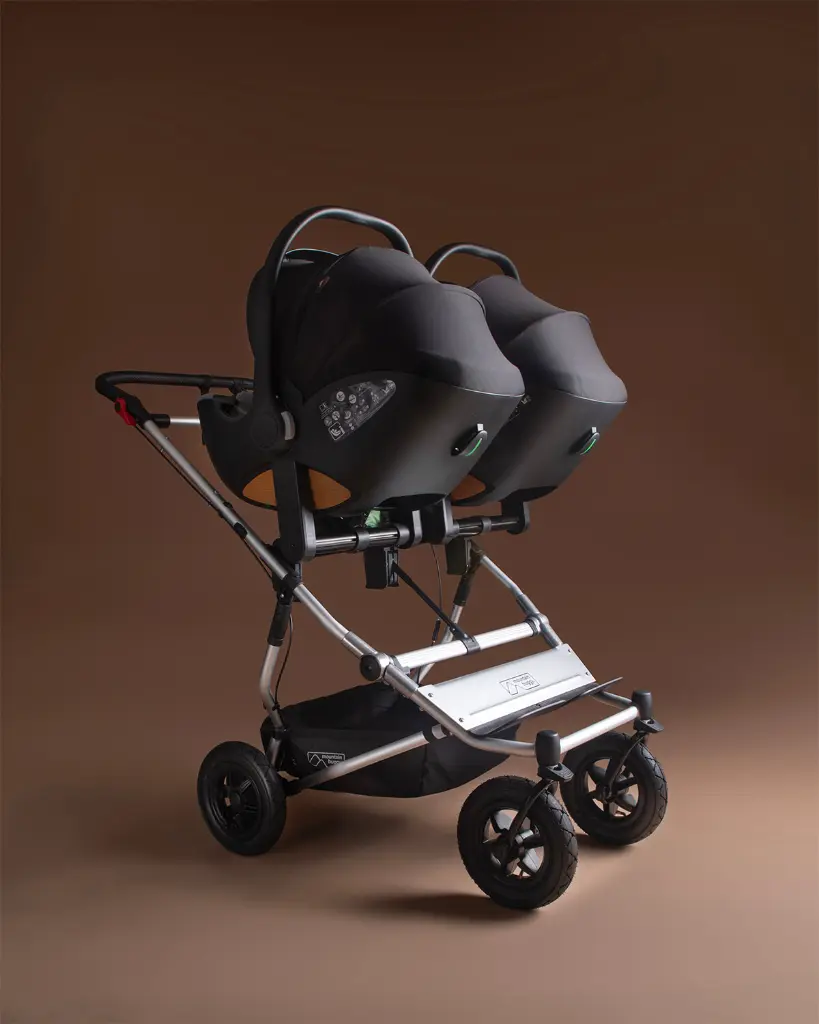 mountain-buggy-nest-car-seat-travel-system-on-Duet-Twin-buggy.webp